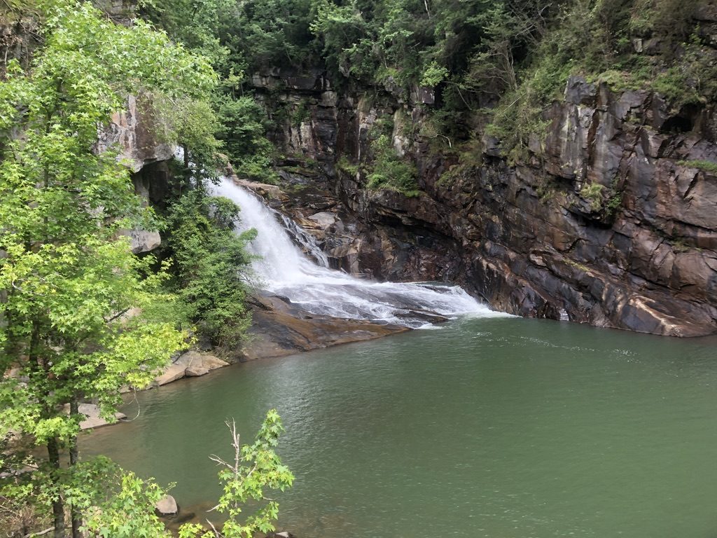 A waterfall pouring into the river at Tallulah Gorge